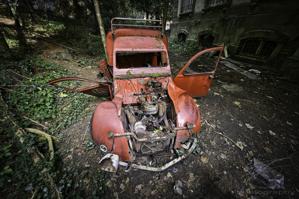 Broken Wings - Old, red car in the back of an abandoned mansion in France