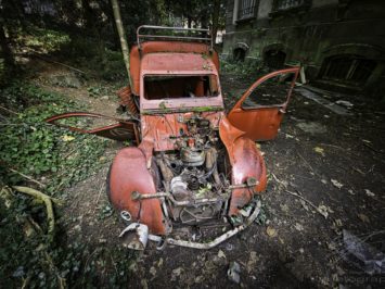Broken Wings - Old, red car in the back of an abandoned mansion in France